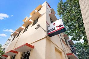 a rock inn sign on the side of a building at Hotel Rose Inn in Kolkata