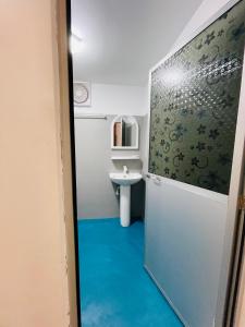 a bathroom with a toilet and a sink at Mermaid Hostel in Trincomalee