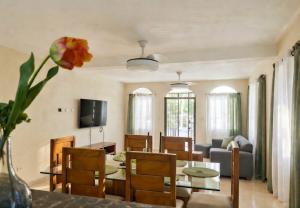 a dining room and living room with a table and chairs at Villa Rosa in San Felipe de Puerto Plata