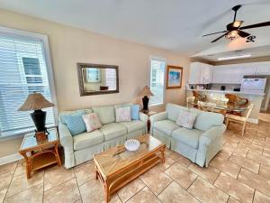 a living room with two couches and a table at Skinny Mini-Beachfront-3BR in St. George Island