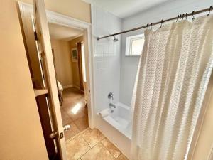 a bathroom with a shower with a shower curtain at Skinny Mini-Beachfront-3BR in St. George Island +44 photos