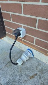 a charger is attached to a brick wall at Vedo apartment 3 Тячів in Tyachiv