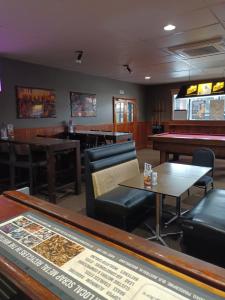 a bar with couches and tables and a pool table at GRAND CENTRAL HOTEL PROSERPINE in Proserpine