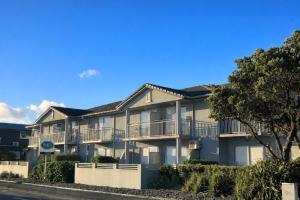 an apartment building with balconies on the side of the street at BKs Premier Motel Esplanade in Lower Hutt