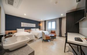 a hotel room with two beds and a bathroom at 호텔이데아 울산삼산점 in Ulsan
