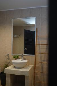 a bathroom with a sink and a mirror at Base 22 Hatyai in Ban Rai +7 photos