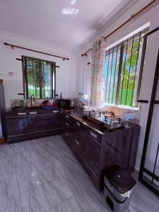 a bathroom with a large wooden vanity and windows at Cool Breeze Villa No 2 in Grand-Baie