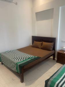 a bedroom with a bed with a zebrakered blanket at Sedna hotel in Mahawewa