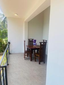 a dining room with a table and chairs on a balcony at Sedna hotel in Mahawewa