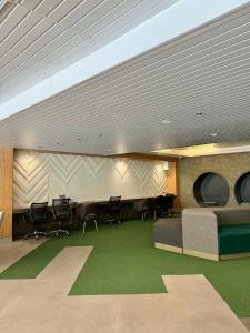 a conference room with chairs and a table and a couch at Blanc Suite in Pasong Bayog +3 photos