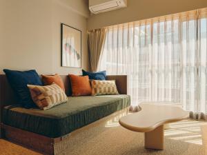 a living room with a couch and a table at illi Tas Shinjuku in Tokyo