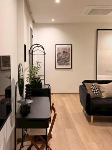 a living room with a couch and a table at The Atelier House in Krabi