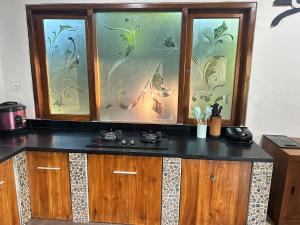 a kitchen with a counter with a fish tank at Nada Garden villa in Jinengdalem