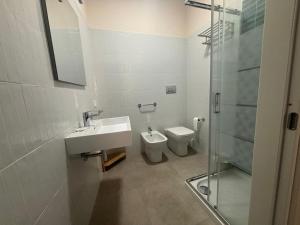 a bathroom with a toilet and a sink and a shower at ModicAlta in Modica +6 photos