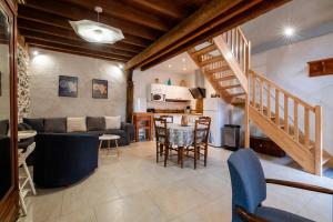 a living room with a couch and a table at Gîte Léon - Au cœur du village 4 pers in Gargilesse-Dampierre +23 photos