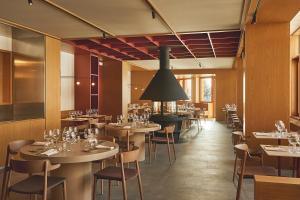 a restaurant with tables and chairs in a room at Rifugio Colere 1600 by Cloud 7 in Colere