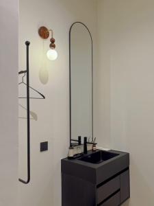 a bathroom with a black sink and a shower at The Atelier House in Krabi