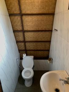 a small bathroom with a toilet and a sink at Giri Garden Sunset Glamping in Gitgit +38 photos