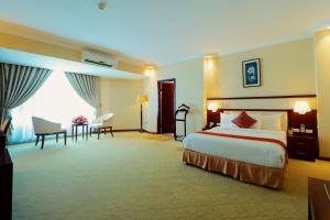 a large hotel room with a bed and a desk at Planet Hotel in Mekʼelē +47 photos
