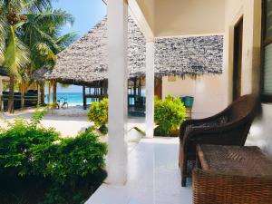 a porch with chairs and a view of the ocean at Zava Nungwi in Nungwi +66 photos