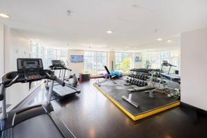 a gym with several treadmills and cardio machines at Modern Corner apartment in downtown in Vancouver +9 photos