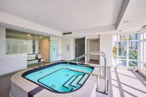 a large bathroom with a swimming pool in a house at Modern Corner apartment in downtown in Vancouver