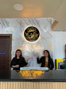 two women standing in front of a counter at Ngs Suites in Sampong