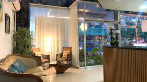 a living room with two chairs and a window at Ngs Suites in Sampong