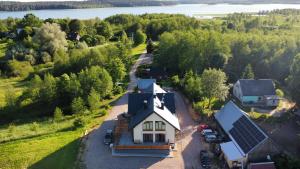 an aerial view of a house with a solar roof at Rosochate Wzgórze pokoje nad jeziorem Wigry in Rosochaty Róg