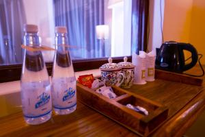 two bottles of water sitting on a wooden table at Royal Soma Resort in Stak