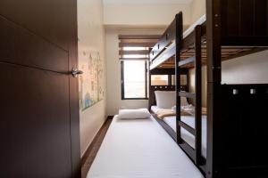 a room with two bunk beds and a corridor at 2BR Cloud 512 with Parking Slot in Baguio +5 photos