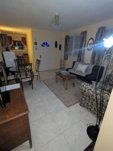 a living room with a couch and a table at Comsee Apartment Saint Mary in Highgate