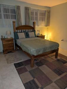 a bedroom with a large bed and two night stands at Comsee Apartment Saint Mary in Highgate