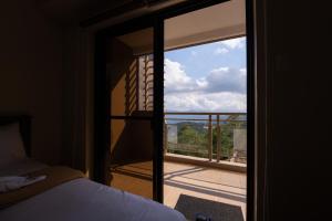 a bedroom with a glass door leading to a balcony at 2BR Cloud 512 with Parking Slot in Baguio