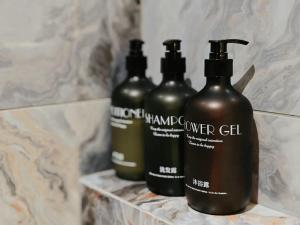 a group of three shampoo bottles sitting on a counter at Hotel Classic in Malacca +11 photos