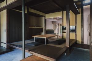 a room with a wooden table and a desk at MUDANI 達磨町 Darumacho in Kyoto