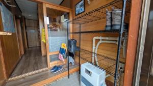 a bird cage in a room with a hallway at Tokachi Base Camp in Kami-furano