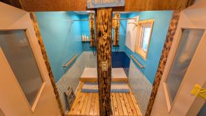 a bathroom with blue walls and wooden stairs at Tokachi Base Camp in Kami-furano +39 photos