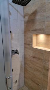 a bathroom with a shower with a glass door at Sobe Magnolija, self check-in in Vinkovci