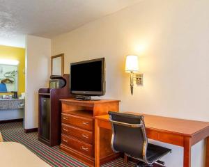 a hotel room with a desk with a computer and a television at Quality Inn Dyersburg I-155 in Dyersburg