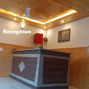 a large fireplace in a room with aederation sign on the wall at Elite peak hotel in Kasauli