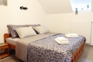 a bedroom with a bed with two towels on it at Bled Castle View Apartment Medina in Zgornje Gorje