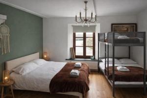 a bedroom with two bunk beds and a window at B&B Ferme1883 in Lierneux