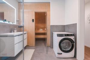 a washer and dryer in a kitchen with a sink at Lütt Mööv - Seestraße 8 4 in Kellenhusen