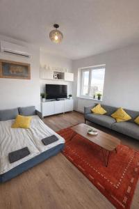 a living room with a couch and a table at Riverside apartment by the Danube in Budapest