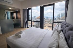 a bedroom with a white bed with a large window at klcc Star residence Kuala Lumpur in Kuala Lumpur +110 photos