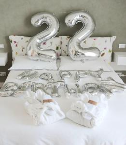 a bed with two silver balloons and two napkins at Bardolino Suite in Bardolino +19 photos
