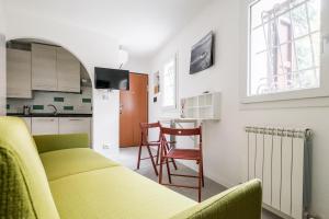 a living room with a couch and a kitchen at Piccola dimora Casalecchio vicino al GranReno e Unipol in Zola Predosa