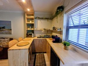 a kitchen with a large wooden counter and a window at GreenPeace in Stellenbosch