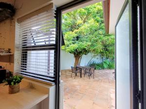 a sliding glass door leading to a patio with a table at GreenPeace in Stellenbosch +6 photos